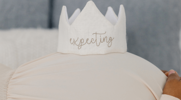 pregnant woman with a pregnancy announcement crown