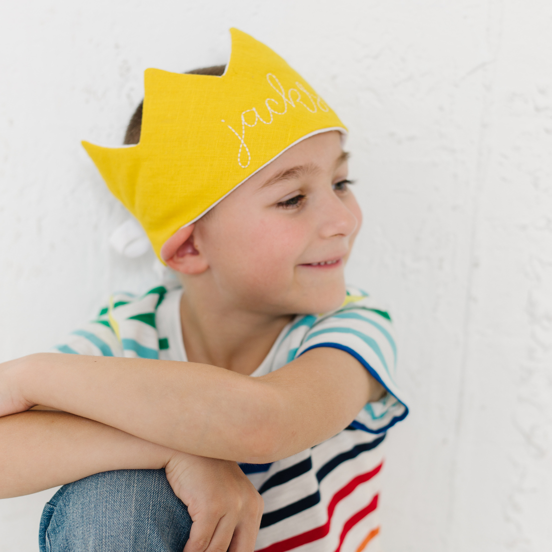 boy wearing yellow crown for birthday