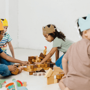 kids playing with blocks and wearing custom crowns at a birthday party