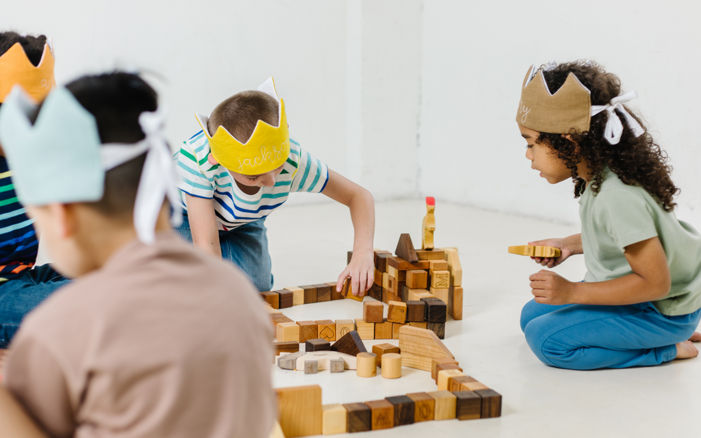 kids imaginative play with dress up crowns and wooden blocks