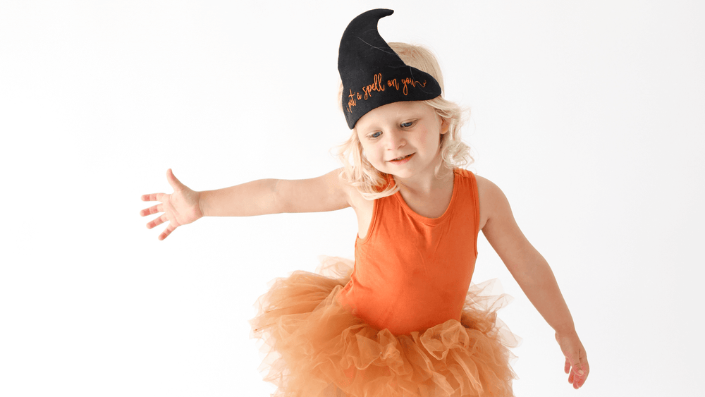 little girl wearing a halloween witch hat
