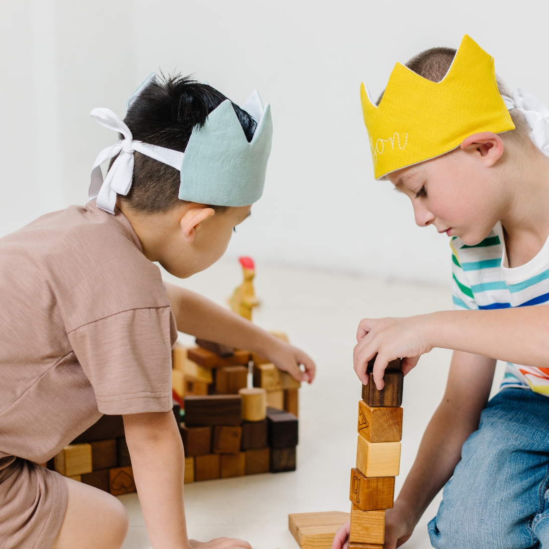 boys wearing colorful crowns and playing