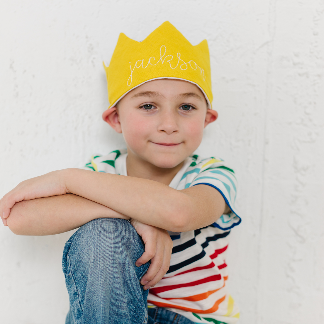 boy wearing gold birthday crown with his name on it