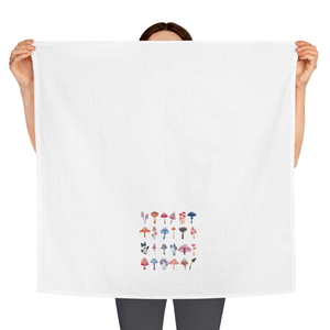 woman holding dish towel with colorful mushrooms on it