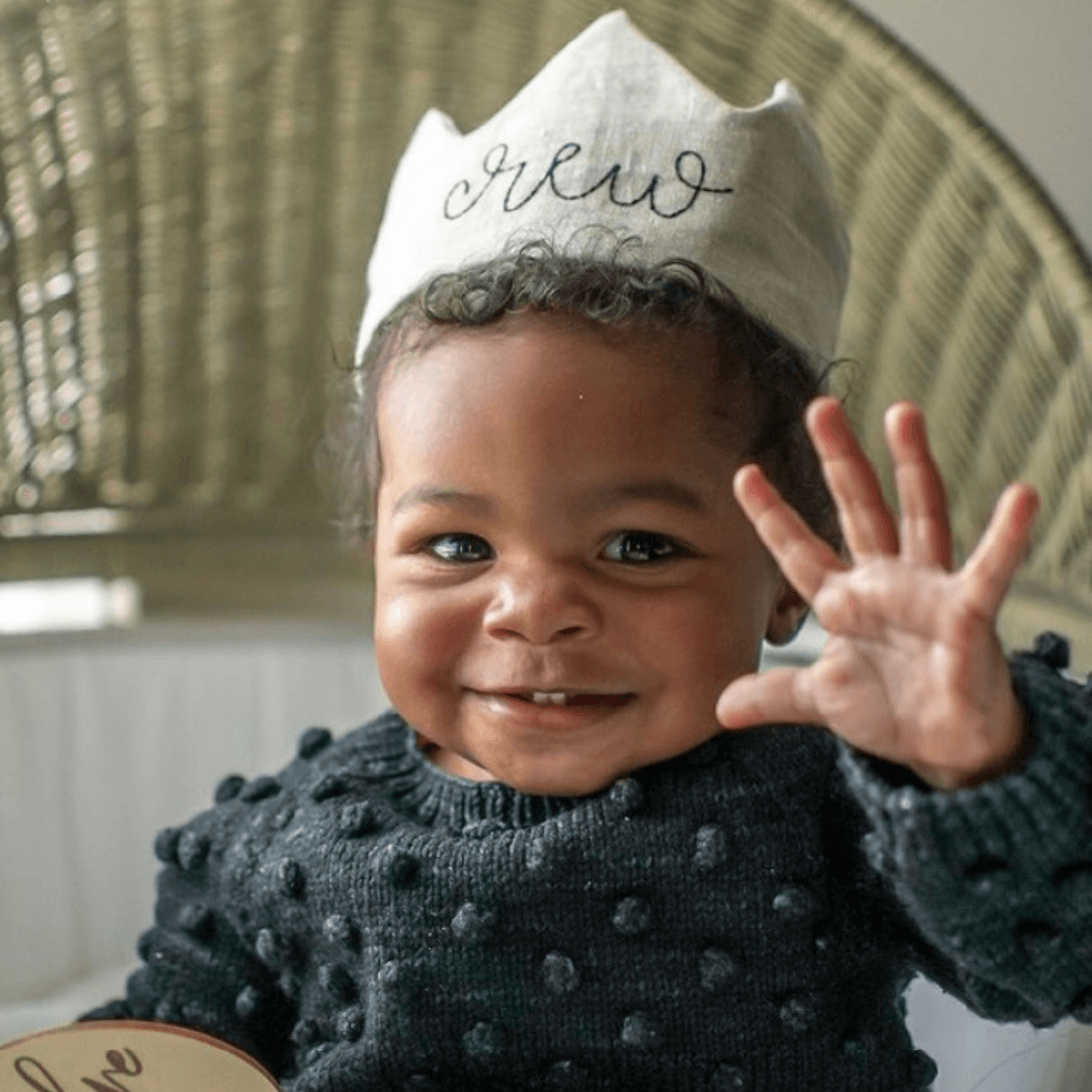 baby boy wearing first birthday crown with his name on it