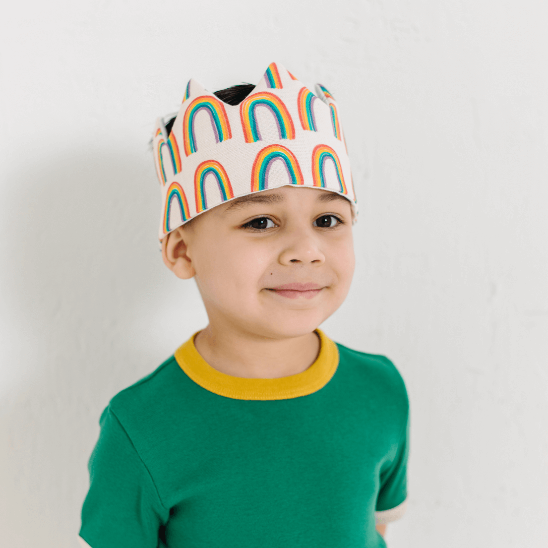 BOY WEARING RAINBOW CROWN