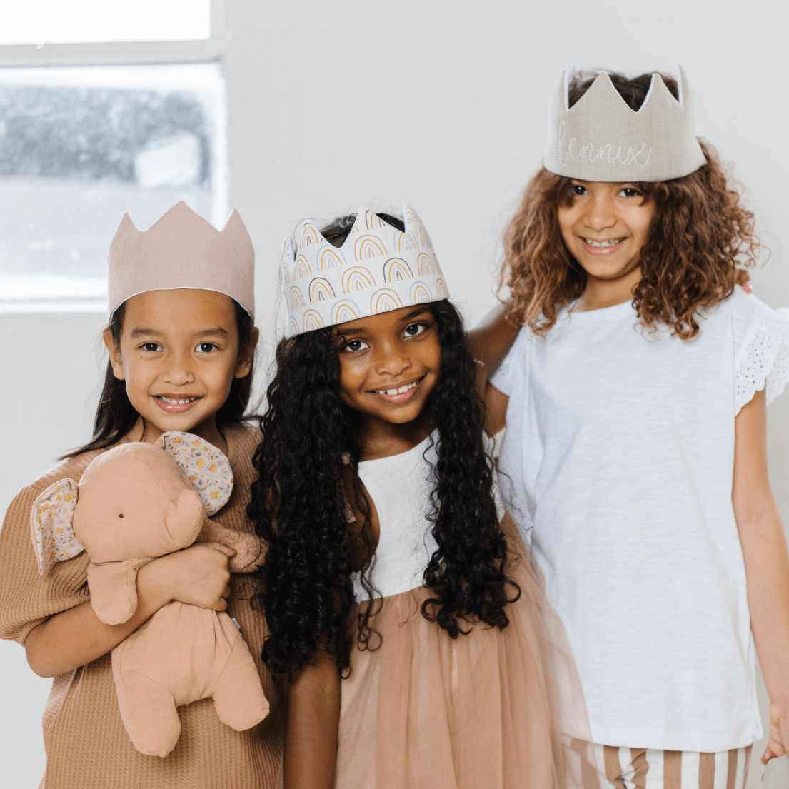 three girls wearing birthday hats