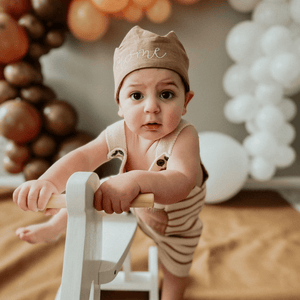 little boys first birthday in brown birthday outfit and matching crown
