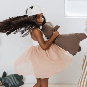 pastel rainbow crown on little girl twirling